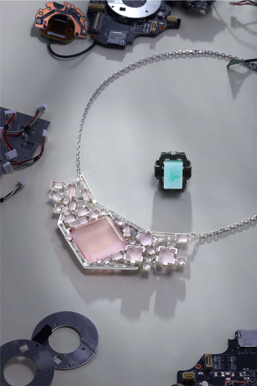Computing Power Jewelry — silver necklace with pink quartz, surrounded by circuit board components